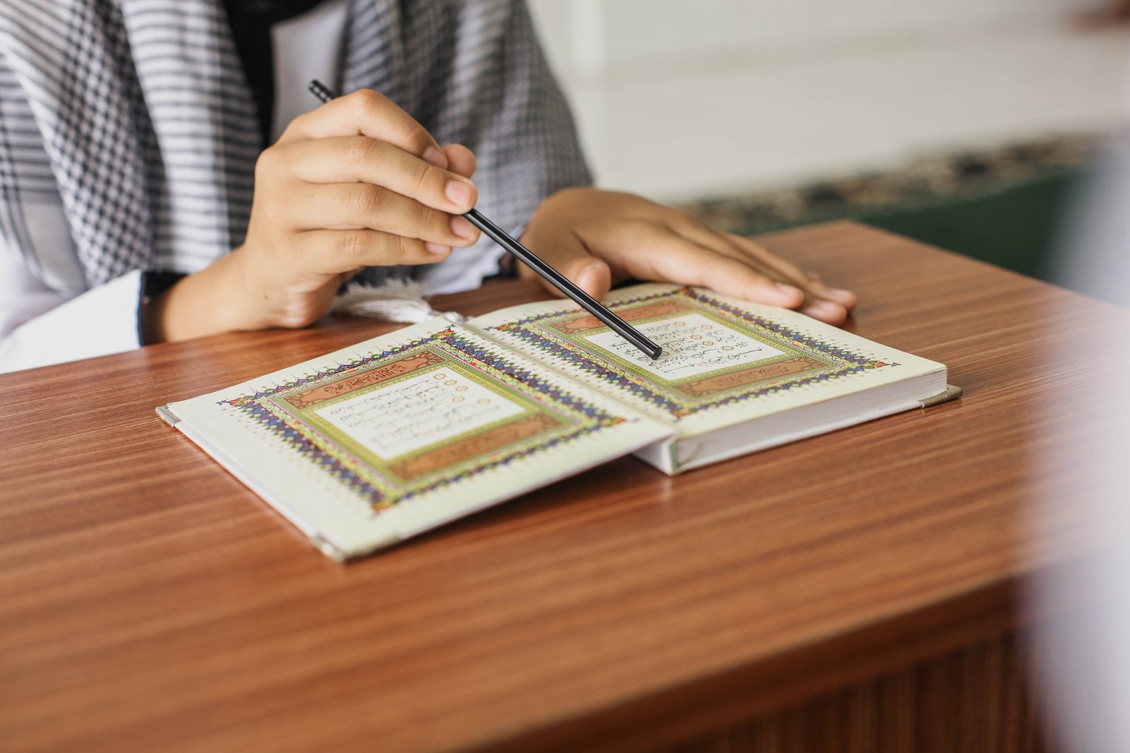 Muslim hand reading Quran